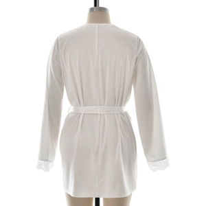 Detail view of white silk robe featuring elegant lace trim on sleeves and back tie closure