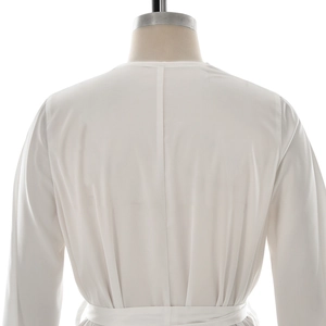 Back view of white long sleeve lace loungewear with adjustable waist tie and minimalist design