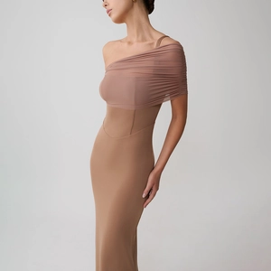 Detail of one-shoulder ruching and mesh fabric on a slim-fit elegant evening dress