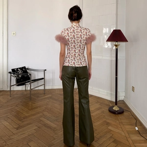 Slim fit floral top with pink feather cuffs and olive green faux leather trousers