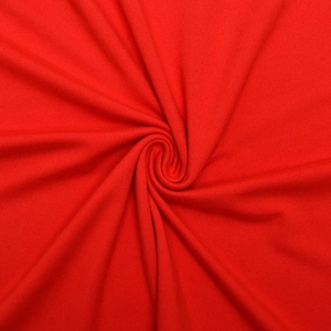 Gros plan sur le tissu en maille rouge vif montrant la texture douce et le tissage élastique