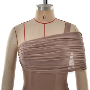 Detail of elegant one-shoulder dress with pleated mesh overlay and ruched fabric design