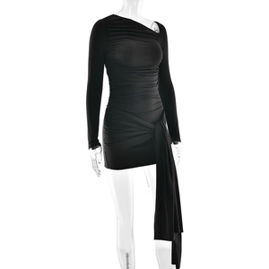 Detail view of black one-shoulder ruched dress with side tie and pleated fabric texture