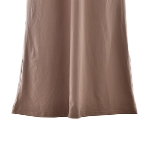 Detailed view of the brown dress hem with clean double-stitched seams and smooth fabric