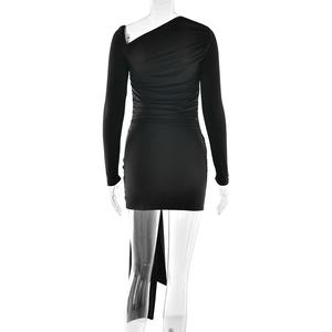 Macro detail of black pleated fabric and asymmetrical hemline on one-shoulder dress