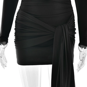Detail of ruched black mini skirt with asymmetric side tie and wrap waist design