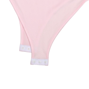 Detail of pink bodysuit crotch with three white resin snap buttons for easy wearing