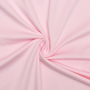 Close-up of soft baby pink knitted fabric texture with elegant silky draped layers
