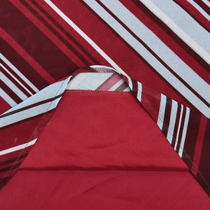 Detail of striped off-shoulder dress showing professional hem stitching and inner lining