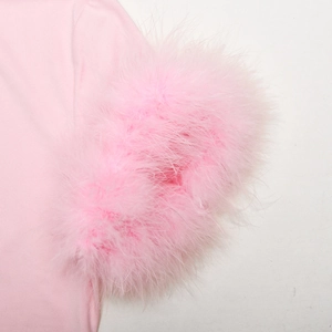 Close-up of pink high neck top showing fluffy ostrich feather trim on the sleeve detail