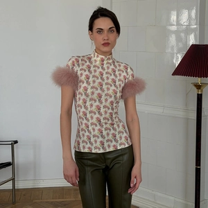 Slim fit floral high neck top with pink feather cuffs and mock neck design