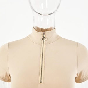 Detail of O-ring silver zipper on beige slim fit bodysuit with stand collar