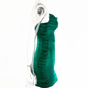 Détail de la robe en satin vert émeraude avec plis latéraux et finition brillante