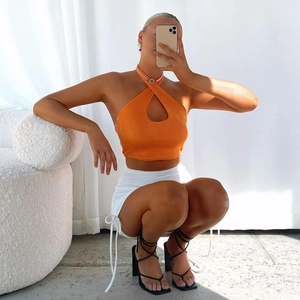 Chic orange halter cross neck top and white mini skirt set for stylish women outfits