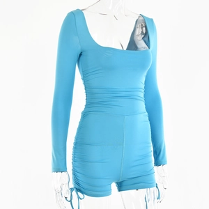 Detail view of sky blue romper with side ruching and adjustable drawstring hem cords
