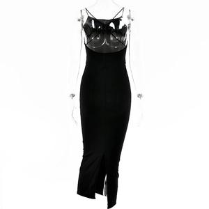 Detail of black slim fit dress featuring an open back with elegant crisscross straps