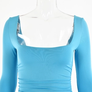 Close-up of sky blue ruched long sleeve romper with a square neckline and elastic fabric