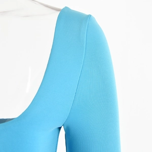 Detail of light blue ribbed knit long sleeve bodysuit showing square neckline and fabric texture