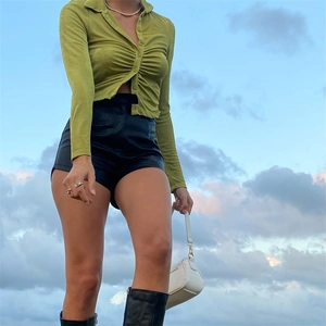 Close-up of grass green slim cardigan featuring ruched front detail and matching buttons
