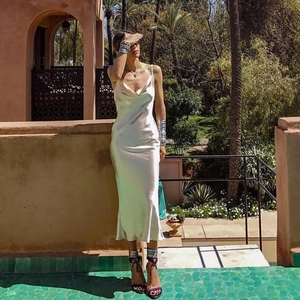 Detail of champagne satin slip dress featuring elegant cowl neck and sleek slim fit