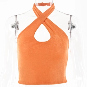 Close-up of bright orange criss-cross halter crop top featuring a keyhole chest cutout