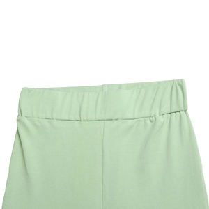 Détail du pantalon évasé vert menthe à taille haute montrant l'élastique et les plis