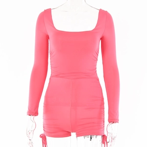 Detailed view of pink long sleeve romper with square neck and ruched waist details