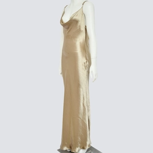 Detail of champagne gold satin maxi dress with a cowl neck and silk-like texture