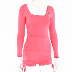 Close-up of ruched side details and adjustable drawstrings on a hot pink romper