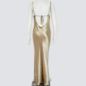 Detail of champagne gold satin backless maxi dress showing strappy lace-up back design