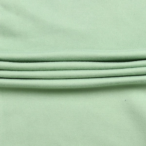 Détail macro du tricot côtelé vert menthe avec texture respirante et élastique