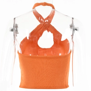 Macro detail of bright orange ribbed knit fabric on a cross halter neck crop top
