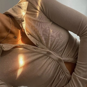 Close-up of khaki ribbed knit top showing fine texture and stylish button-down collar