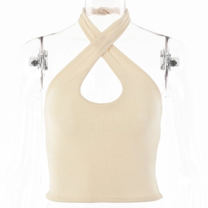 Detail of beige halter cross top featuring a teardrop cutout and ribbed knit texture
