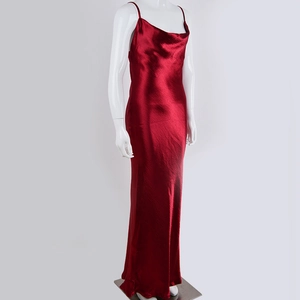 Detail of elegant dark red satin maxi dress with cowl neck and silky draped fabric texture