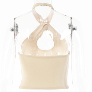 Macro view of the beige ribbed knit fabric and cross halter neck detail on the slim top