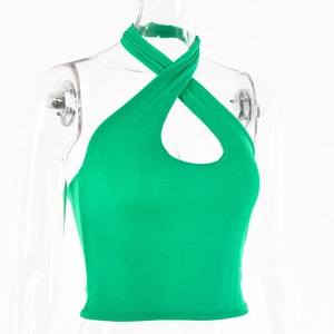 Detail of cross halter neck and teardrop cutout on bright green ribbed knit top