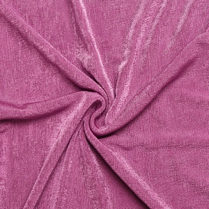 Détail de tissu plissé rouge rose avec éclat métallique et finition texturée brillante