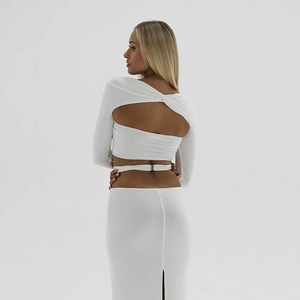 Completo bianco con top corto a maniche lunghe senza schiena e gonna lunga a vita alta
