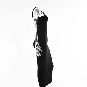 Detail view of black slim fit dress featuring a single shoulder strap with silver buckle