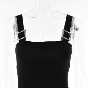 Detail of square rhinestone buckles on black strapless dress with square neckline
