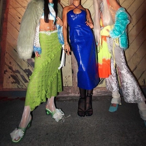 Detail of light green ruffled lace skirt and blue glossy mini dress in Y2K aesthetic