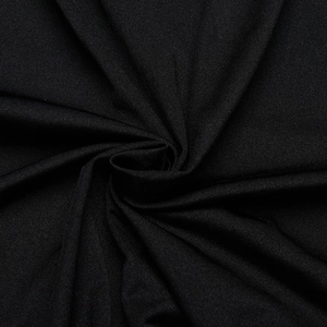 Close-up of black textile fabric showing fine texture and soft drape of the dress