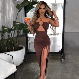 Detail of ruched side and high slit on a deep brown halter neck slim fit dress