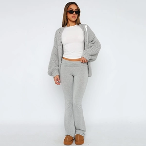 Three-piece lounge set with grey knit cardigan, white crop top, and high-waist pants