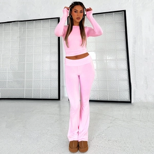 Chic pink two-piece set featuring slim-fit long sleeve top and high-waist flared pants