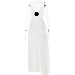 Elegant white V-neck maxi dress with a decorative black 3D flower and thin straps