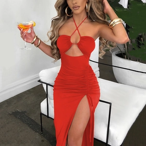 Detail of red halter neck dress featuring front cutout, ruching, and high side slit