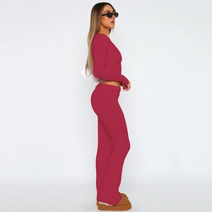 Detail view of burgundy two-piece set featuring cropped long sleeve top and flared yoga pants