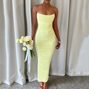 Detail showing elegant yellow ruched fabric and slim fit strapless maxi dress texture